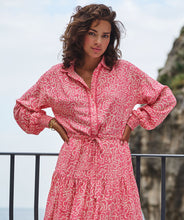 Load image into Gallery viewer, If you love pink, you'll love this darling dress by EsQualo! Not only is the color stunning, but the detailing is high end. A lace edging runs down the front button closure, creating an eye-appealing addition while the subtle tiered bottom and elasticized cuffs add even more interest. The belt in tie allows for cinching at the waist and button-down top portion includes pink buttons. Colors- Pink and cream. Button-down top portion. Built in tie waist. Subtle tiered bottom. Elasticized sleeves.