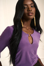 Load image into Gallery viewer, This stunning tunic designed by Joseph Ribkoff offers a graceful fit and an eye-catching look, with a vivid violet hue and a silver-ring keyhole detail on both the front and the back. Its effortless style ensures that it will be a statement piece in your wardrobe. Color- Violet. Tunic length. Keyhole design. Silver ring hardware in front and back. Fabric- 96% Polyester. 4% Spandex.