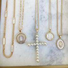 Load image into Gallery viewer, Our Vivian Pearl Cross Necklace is an attention grabber with its gorgeous array of faux pearls in a cross design. A bold piece to wear alone or layer with your favorite necklaces, this will become one of your favorite go to necklaces. Color- Gold and white. Faux pearls. Twenty inch box chain. 14 kt gold plate over brass.