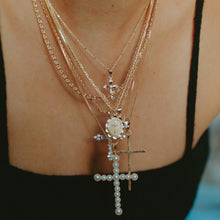 Load image into Gallery viewer, Our Vivian Pearl Cross Necklace is an attention grabber with its gorgeous array of faux pearls in a cross design. A bold piece to wear alone or layer with your favorite necklaces, this will become one of your favorite go to necklaces. Color- Gold and white. Faux pearls. Twenty inch box chain. 14 kt gold plate over brass.