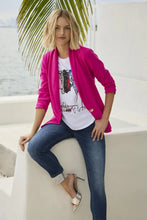 Load image into Gallery viewer, This fun fashion tee is a vibrant and stylish addition to your wardrobe. This knit top features a lively white and multi-color print of a stylish lady standing next to a rack of stylish apparel and shoes/purses. A soft fabrication provides ultimate comfort and style. The design is perfect for brightening up your casual or work attire, and it pairs effortlessly with jeans, trousers, or skirts and is so stylish when worn under a blazer or favorite jacket.