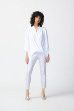 Load image into Gallery viewer, These high-quality denim jeans feature a classic and elegant design with a shimmering foil animal print. The slim crop silhouette provides versatility, while the hidden elastic waistband ensures comfort and security. Color- White and silver. Foiled twill. Hidden elastic waistband. Two back pockets. Unlined.