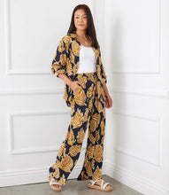 Load image into Gallery viewer, Immerse yourself in the luxury of these pants, expertly made from a premium blend of viscose for a silky-smooth feel against your skin. The wide-leg silhouette provides a flattering and flowy fit, ensuring both comfort and a chic appearance.