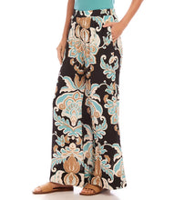 Load image into Gallery viewer, Step into effortless sophistication with the Wryn Wide Leg Pants in Damask Floral Print by Karen Kane. These elegant pants feature a stunning damask floral design in soft brown and blue hues, adding a touch of refinement to your wardrobe. The wide-leg silhouette creates a flattering and modern look, while the elasticized waist and convenient side pockets ensure practicality without compromising elegance.
