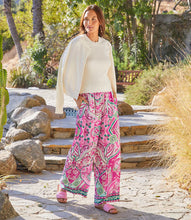 Load image into Gallery viewer, The Wyndy Wide Leg Pants in Pink and Green Multicolor Print by Karen Kane are stylish wide-leg pants featuring a striking Italian tile border print on smooth crepe fabric. They are fitted at the waist and relaxed at the hips, offering a comfortable drape with a pull-on elastic waistband and functional side pockets. Ideal for pairing with solid tops or matching prints, these wide-leg pants can be dressed up with heels or kept casual with sandals.