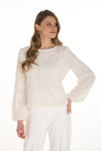 Load image into Gallery viewer, Woman wearing a white sequin top and white pants against a white background.