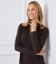 Load image into Gallery viewer, Woman wearing a brown zip-up dress against a white wall.