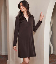 Load image into Gallery viewer, Woman wearing a brown dress standing against a neutral wall.