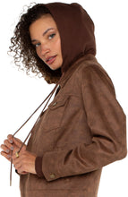 Load image into Gallery viewer, Introducing our new trucker jacket, complete with a detachable hood. The rich, earthy hue enhances the faux leather material, adding a layer of sophistication. This versatile and chic jacket is an indispensable addition to the wardrobe of any contemporary explorer.