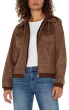 Load image into Gallery viewer, Introducing our new trucker jacket, complete with a detachable hood. The rich, earthy hue enhances the faux leather material, adding a layer of sophistication. This versatile and chic jacket is an indispensable addition to the wardrobe of any contemporary explorer.