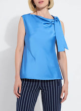 Load image into Gallery viewer, The Zulena Bow-Tie Neck Top in vibrant Electric Blue is a true wardrobe essential for fashion-forward individuals. Designed with a straight, cropped fit that runs true to size, this sleeveless top is crafted from luxurious Soft Touch Satin for a smooth, elegant feel. Cut on the bias for a flattering drape, it features stylish details such as a diagonal back seam, chic side slits, and an adjustable shoulder tie, making it the perfect blend of comfort and sophistication.