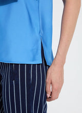 Load image into Gallery viewer, The Zulena Bow-Tie Neck Top in vibrant Electric Blue is a true wardrobe essential for fashion-forward individuals. Designed with a straight, cropped fit that runs true to size, this sleeveless top is crafted from luxurious Soft Touch Satin for a smooth, elegant feel. Cut on the bias for a flattering drape, it features stylish details such as a diagonal back seam, chic side slits, and an adjustable shoulder tie, making it the perfect blend of comfort and sophistication.