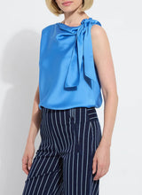 Load image into Gallery viewer, The Zulena Bow-Tie Neck Top in vibrant Electric Blue is a true wardrobe essential for fashion-forward individuals. Designed with a straight, cropped fit that runs true to size, this sleeveless top is crafted from luxurious Soft Touch Satin for a smooth, elegant feel. Cut on the bias for a flattering drape, it features stylish details such as a diagonal back seam, chic side slits, and an adjustable shoulder tie, making it the perfect blend of comfort and sophistication.