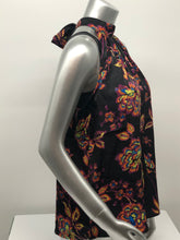Load image into Gallery viewer, A beautiful black base with vibrant neon floral pattern in lime green, yellow, purple, turquoise and orange creates a stunning mock neck top. A dramatic finishing touch is a tie at the base of the neck. With a fabric that is soft and cool to the touch, you will not only be stylish but comfortable at the same time.