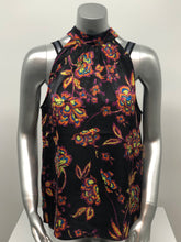 Load image into Gallery viewer, A beautiful black base with vibrant neon floral pattern in lime green, yellow, purple, turquoise and orange creates a stunning mock neck top. A dramatic finishing touch is a tie at the base of the neck. With a fabric that is soft and cool to the touch, you will not only be stylish but comfortable at the same time.