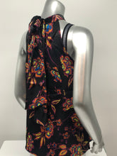 Load image into Gallery viewer, A beautiful black base with vibrant neon floral pattern in lime green, yellow, purple, turquoise and orange creates a stunning mock neck top. A dramatic finishing touch is a tie at the base of the neck. With a fabric that is soft and cool to the touch, you will not only be stylish but comfortable at the same time.