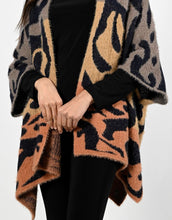 Load image into Gallery viewer, A striking abstract print in orange, black and brown comes alive on this stunning cardigan. Fuzzy, cozy and warm, this fabulous cardigan will become your next cold weather favorite.