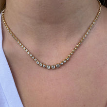 Load image into Gallery viewer, This stunning graduated tennis necklace is made with a classic silhouette and is accented with a milgrain border for vintage vibes. Wear alone or layer with other necklaces.