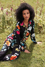 Load image into Gallery viewer, The Nalini floral pants from Joseph Ribkoff epitomize both comfort and style. Adorned with a vivid and lively floral design, these wide-leg pants are bound to garner admiration. The Nova features an easy pull-on design and an elastic waistband for supreme comfort. Its smooth, silky knit material offers a touch of luxury.