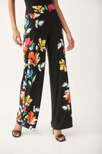 Load image into Gallery viewer, The Nalini floral pants from Joseph Ribkoff epitomize both comfort and style. Adorned with a vivid and lively floral design, these wide-leg pants are bound to garner admiration. The Nova features an easy pull-on design and an elastic waistband for supreme comfort. Its smooth, silky knit material offers a touch of luxury.
