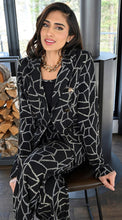 Load image into Gallery viewer, Our Blakely jacket is pure sophistication and style with its high-quality fabrication and design. The metallic threading in an abstract print, creates the perfect style for holiday dressing and other formal occasions such as winter weddings or dinners. Shiny metallic buttons in oval like shapes add greater interest to this perfect jacket. Color- Black and metallic. Oval shape buttons. Hook and eye closures. Nonfunctional front pockets.