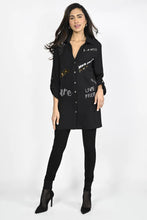 Load image into Gallery viewer, Such an amazing top, our Britta is a sophisticated tunic length woven knit top with wording that pops against the black background. Shiny sequins and lettering reflect the light and get you noticed! Pairs beautifully with black leggings, providing a very stylish and chic look. Color- Black. Sequin and shiny lettering. Crystal buttons. Tab roll sleeves. Words such as "Live Free" "Mon Coeur" (My heart) "A La Mode" "Amore" and more.