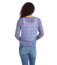 Load image into Gallery viewer, Various floral and shapes print in colorful blue and red hues brings this figure flattering tie front top to life. The addition of shimmering metallic lurex makes it the perfect way to dress up any outfit. Color- Red and blue. Long sleeve button cuff. V-neck. Tie-front.