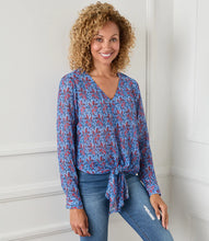Load image into Gallery viewer, Various floral and shapes print in colorful blue and red hues brings this figure flattering tie front top to life. The addition of shimmering metallic lurex makes it the perfect way to dress up any outfit. Color- Red and blue. Long sleeve button cuff. V-neck. Tie-front.
