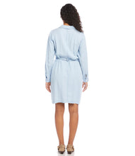 Load image into Gallery viewer, A gorgeous soft and lightweight fabrication shapes an effortlessly feminine shirtdress. Detailed with patch pockets, matching self-tie belt and cinched waist, our Campbell dress is a fashionable look that can easily transition from season to season. Wear with sandals in the summer or pair with your favorite leggings and boots in the winter. Color- Chambray. Chest pockets and side pockets. Button down. Self-tie belt.