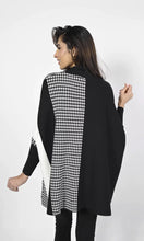 Load image into Gallery viewer, A gorgeous and stylish sweater, our Charisma with color blocking in off-white and black along with a panel of houndstooth, is an incomparable fashion design. Our sweater is designed with dolman sleeves and includes a flattering, generous cut. Color- Black, off-white. Unlined. Dolman sleeve. Approximately 30 inches long, with a 24 inch sleeve.
