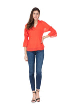 Load image into Gallery viewer, Our Carissa long sleeve top offers a feminine flair with its Swiss dot fabrication, elasticized sleeves and ruffle V-neck design. While the gorgeous sleeves are slightly sheer, the bodice is fully lined. Wear with your favorite denim or dress up with a pair of white or black pants. Color - Coral. Long, sheer sleeves. Fully lined bodice. Ruffle V-neck. Swiss Dot fabrication.