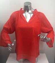 Load image into Gallery viewer, Our Carissa long sleeve top offers a feminine flair with its Swiss dot fabrication, elasticized sleeves and ruffle V-neck design. While the gorgeous sleeves are slightly sheer, the bodice is fully lined. Wear with your favorite denim or dress up with a pair of white or black pants. Color - Coral. Long, sheer sleeves. Fully lined bodice. Ruffle V-neck. Swiss Dot fabrication.
