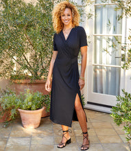Load image into Gallery viewer, Simply elegant and classy is our Alicia Faux Wrap Midi Dress by Karen Kane. A perfect evening-ready midi dress is designed and made from fluid jersey-knit fabric that offers an eye-appealing draping. A side-slit on the left side offers an even greater interest in this gorgeous midi dress.