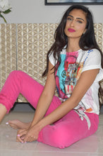 Load image into Gallery viewer, Darling is the perfect word to describe our Fiona vibrant fuchsia jean with triple fringing at hemline. Beautiful stretch and recovery to this playful jean makes this jean ultra-comfortable. It will easily become one of your ultimate favorites! Pair with our Dina Pink Multi Print Top by Frank Lyman for the perfect look. DINA PINK MULTI ABSTRACT PRINT TOP BY FRANK LYMAN – Aurora Lynn Boutique