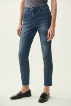 Load image into Gallery viewer, Inspired by the 60's model Twiggy, the Brielle Jean with Sparkle Face Design is truly a work of art that you can wear. This beautiful and comfortable ankle length, classic slim blue jean has a partial female face design on the left leg created with a series of gorgeous sparkling black crystals. You will definitely receive numerous compliments when you wear this work of art. Color- Blue with black crystals.