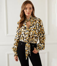 Load image into Gallery viewer, Add a dash of old-world romance to your wardrobe with our Fiona top with smocked sleeves, dramatic collar and tie front. With its unique design, this beautifully unique top can be dressed up or worn casually. You'll be sure to receive compliments when you style this beautiful top. Color-Black, white and gold. Long sleeve with smocked cuff. V-neck with smocked collar.