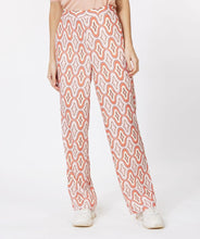 Load image into Gallery viewer, Our Gloria wide leg pant is just "groovy" with its 70's inspired geometric print. These cool pants have side pockets and a blind zipper on the side and have a terrific satin feel. Looks fantastic paired with our BRITTANY BRIGHT PEACH PUFF SLEEVE TOP - ESQUALO and our ODELIA OFF-WHITE BLOUSON SLEEVE T-SHIRT - ESQUALO. Color - Groovy; Coral, peach, off white, light brown, light yellow. Geometric print. Lined. Satin feel fabric. Not a stretch fabrication. Side zipper closure. Wide leg design.