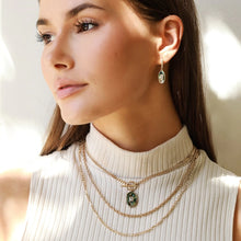 Load image into Gallery viewer, There are statement necklaces, and then there is this striking abalone piece. Shimmering colors pop on this pendant while a crystal baguette accent glimmers with each movement. This lovely necklace is just as unique as you.