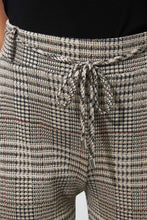 Load image into Gallery viewer, Preppy printed jacquard gets an athleisure-inspired refresh with the addition of a charming tie front with belt loops. A light dusting of gold sparkle thread elevates this fashionable pant. Comfortable and chic, this pant is the best of both worlds. Pairs perfectly with our BIANCA BEIGE AND BLACK KNIT JACKET- JOSEPH RIBKOFF 223298 Color- Beige, black, gold and just hints of yellow and dark orange. Elastic waist. Drawstring. Belt loops and self-tie.