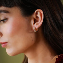 Load image into Gallery viewer, The gorgeous huggies add just the right amount of sparkle to any outfit. The beauty is in the details, with delicate rows of white cubic zirconia that set off the larger champagne cubic zirconia.