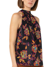 Load image into Gallery viewer, A beautiful black base with vibrant neon floral pattern in lime green, yellow, purple, turquoise and orange creates a stunning mock neck top. A dramatic finishing touch is a tie at the base of the neck. With a fabric that is soft and cool to the touch, you will not only be stylish but comfortable at the same time.