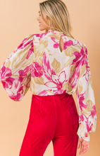Load image into Gallery viewer, Our Ashley floral blouse is both sophisticated and fun! A stunning abstract floral print in pink and taupe on a white base gives this blouse an edge, while billowy sleeves offer a feminine appeal. Gathering at the collar, sleeves and shoulders add that extra flair. Effortlessly pair this blouse with jeans for a casual look or dress up with your favorite bottoms.