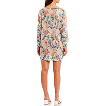 Load image into Gallery viewer, A perfect style to include in your wardrobe, this lightweight sweater is so versatile! Wear as a sweater dress or pair with your favorite bottoms and style as a tunic. Lightweight enough for the spring/summer but also a perfect weight to keep you warm in the fall/winter. A beautiful vibrant flower really pops on the beige background! Colors- Green, pink, orange, yellow, blue and beige. Lightweight knitted sweater. Long sleeve.