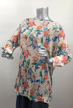Load image into Gallery viewer, A perfect style to include in your wardrobe, this lightweight sweater is so versatile! Wear as a sweater dress or pair with your favorite bottoms and style as a tunic. Lightweight enough for the spring/summer but also a perfect weight to keep you warm in the fall/winter. A beautiful vibrant flower really pops on the beige background! Colors- Green, pink, orange, yellow, blue and beige. Lightweight knitted sweater. Long sleeve.