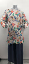 Load image into Gallery viewer, A perfect style to include in your wardrobe, this lightweight sweater is so versatile! Wear as a sweater dress or pair with your favorite bottoms and style as a tunic. Lightweight enough for the spring/summer but also a perfect weight to keep you warm in the fall/winter. A beautiful vibrant flower really pops on the beige background! Colors- Green, pink, orange, yellow, blue and beige. Lightweight knitted sweater. Long sleeve.
