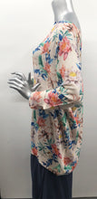 Load image into Gallery viewer, A perfect style to include in your wardrobe, this lightweight sweater is so versatile! Wear as a sweater dress or pair with your favorite bottoms and style as a tunic. Lightweight enough for the spring/summer but also a perfect weight to keep you warm in the fall/winter. A beautiful vibrant flower really pops on the beige background! Colors- Green, pink, orange, yellow, blue and beige. Lightweight knitted sweater. Long sleeve.