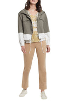 Load image into Gallery viewer, If you are searching for a jacket with a fresh take on a simple style, our Meriam jacket in moss green is the jacket for you! With so many interesting details- hidden zippered placket, adjustable draw cord hem, stand up collar, drop shoulder sleeves with elastic cuffs and chest patch pockets, this winning jacket will get you noticed! In addition, you are going to love the super soft cotton twill fabric. Pair with our MECA LIGHTWEIGHT MOSS GREEN MESH TURTLENECK for the perfect look!