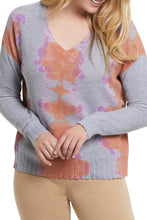 Load image into Gallery viewer, A V-neck sweater is an effortless must-have—perfect for throwing on and looking fabulous at a moment's notice. Make a fashion statement in this lovely long sleeve V-neck sweater in vivid, gorgeous colors, called Sunkissed. Colors- Sunkissed; gray base with splashes of coral and lavender. Pop-over V-neck. Relaxed fit. Drop shoulder contrast sleeves. Ribbed cuffs and hem. Soft combed cotton.