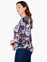 Load image into Gallery viewer, A striking vintage pattern creates an eye-appealing design on this flowy peasant shirt silhouette. Modern details like an elastic cuff and smock detailing ad even more beauty to this gorgeous top. The fabric used to create our Misty has been mindfully made from EcoVero rayon that uses sustainable material and less water. Color-Indigo Mix- Navy, light blue, coral, tan, white, yellow, purple. Woven top. Relaxed fit. Split neck. 3/4 sleeve. Basic sleeve. Tie front. Sits at hip.