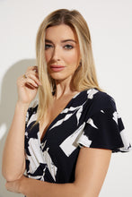 Load image into Gallery viewer, An elegant dress, our Melinda fit and flare dress is a flattering design in a brilliant midnight blue and vanilla color. Featuring a flattering cross-over front, elastic tie waist double frill hemline and frill cap sleeves this dress has elegant movement and is attractive on all figures.